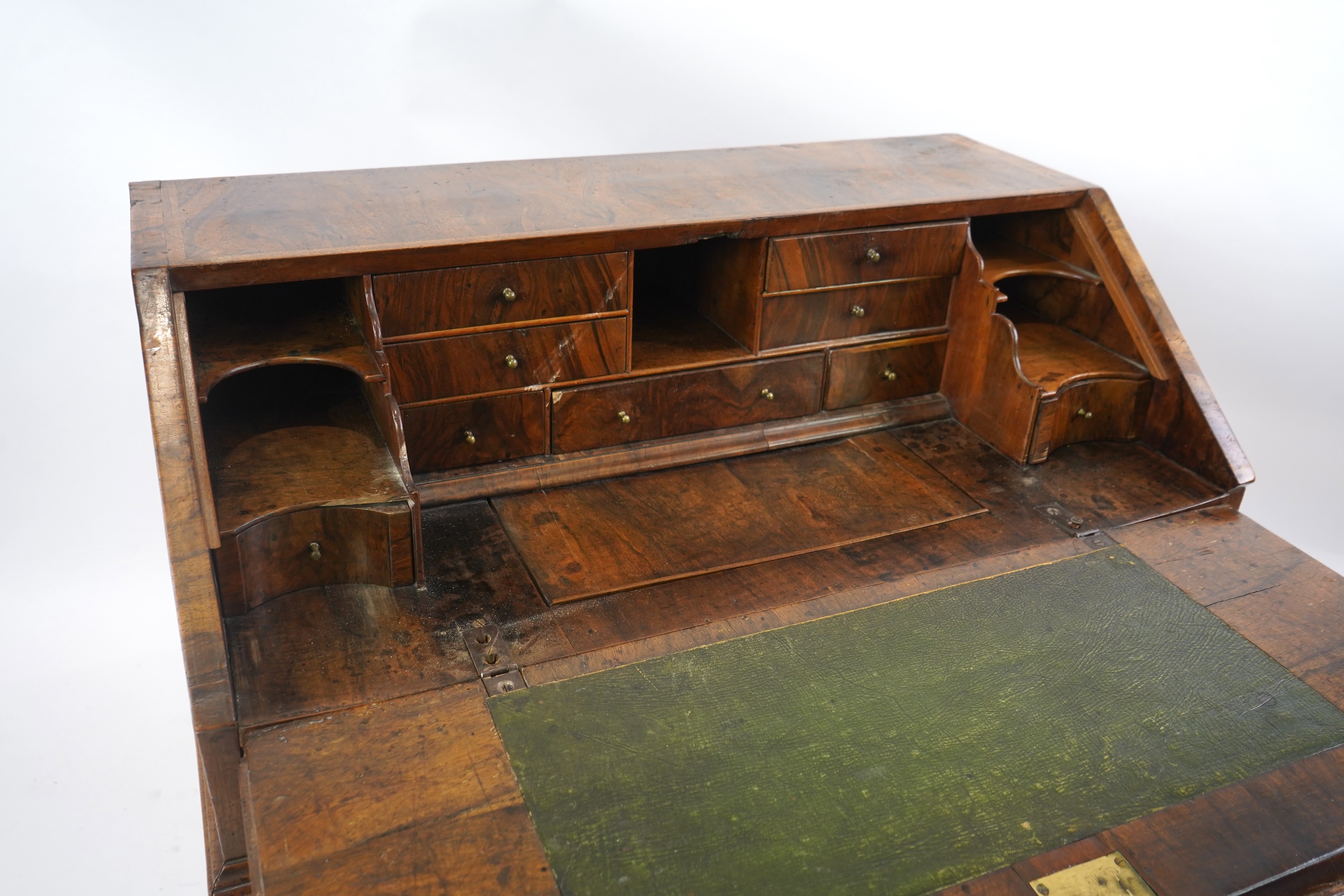 A George I feather banded walnut bureau